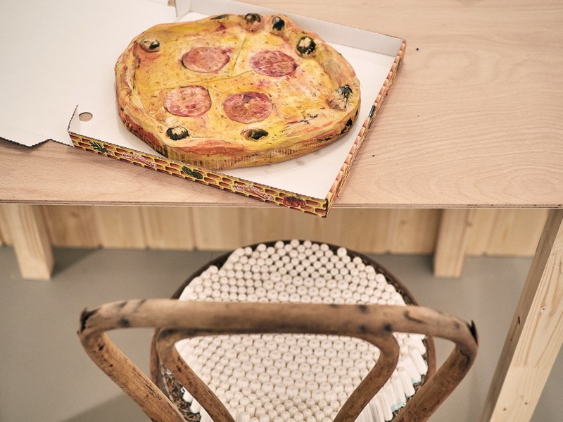 Die Lieblingspizza des Sohnes in Holz und ein Küchenstuhl mit Tampon-Bezug. Christine Lederer, bildende Künstlerin und alleinerziehende Mutter, zeigt in "Alle Frauen sind immer daheim" Alltagsgegenstände aus künstlerischer und feministischer Sicht (© Miro Kuzmanovic/Galerie Hollenstein Lustenau)